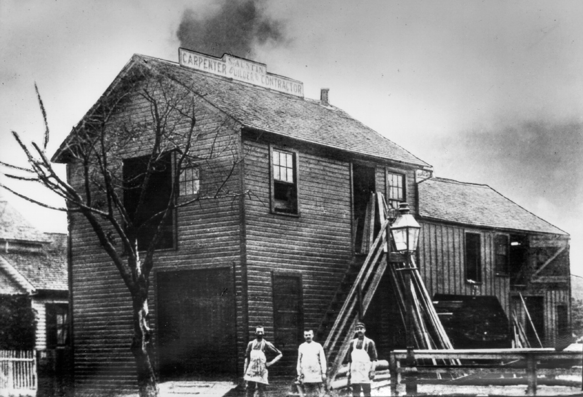 Historical photo of the original Austin Company workshop in Cleveland, Ohio, with workers standing in front