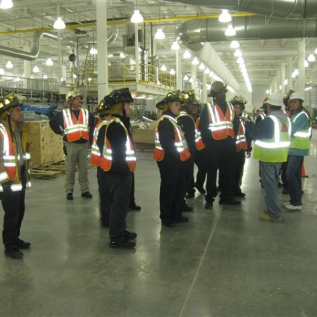 Construction workers gathered in a facility for a safety meeting