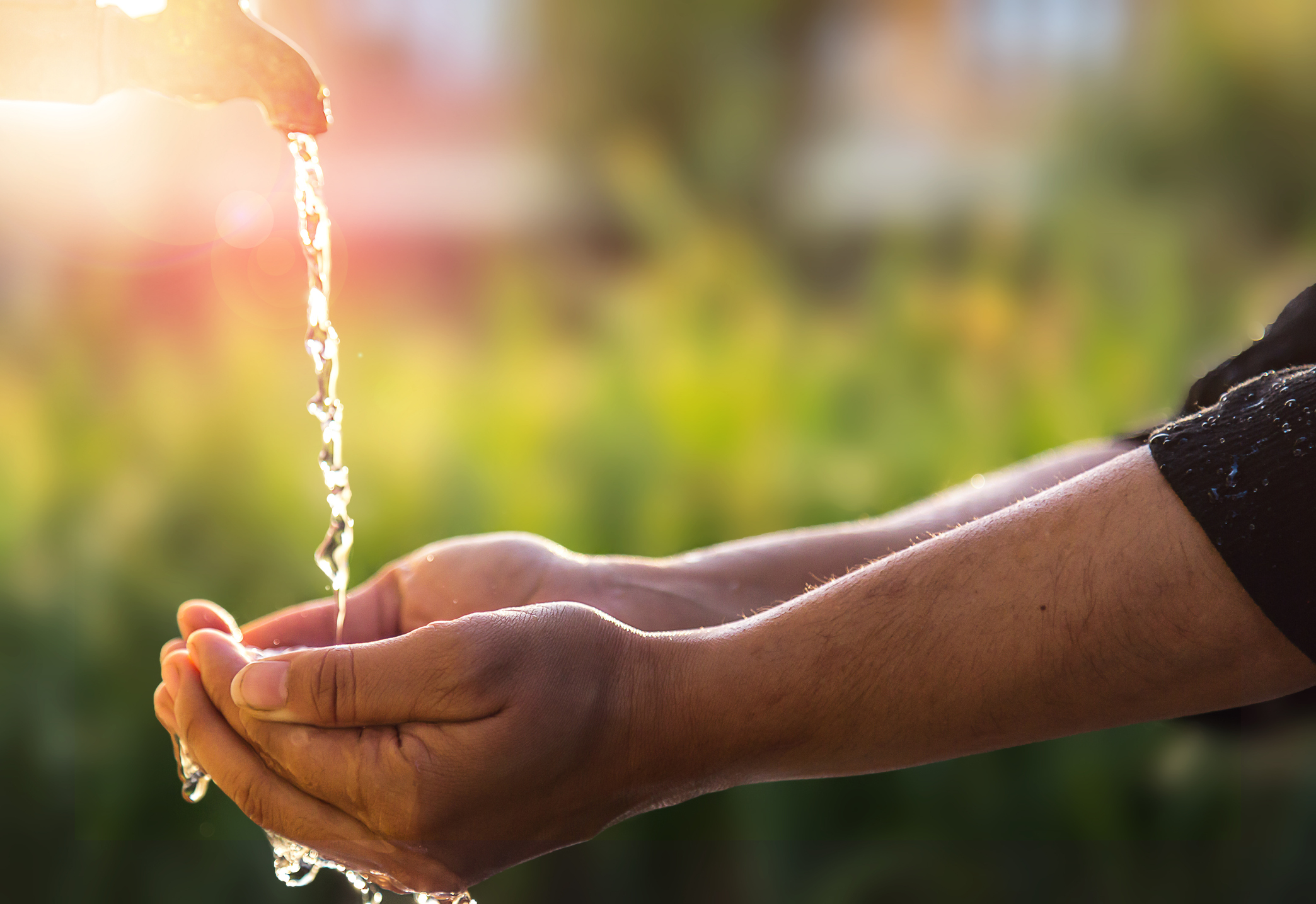 Child’s Hands Under Water Tap